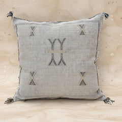 Textured pillow with geometric patterns on a white background